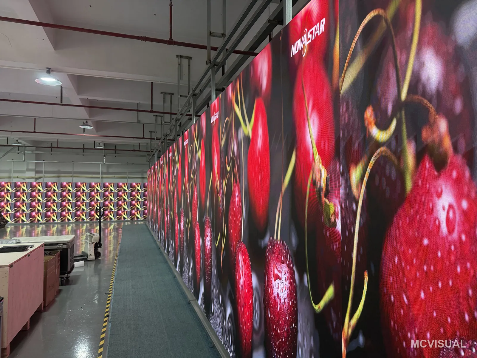MCVISUAL factory aging bay, Shenzhen, China — Saturated red, the colour that exposes binning differences first. If a batch is going to disagree with itself, it disagr