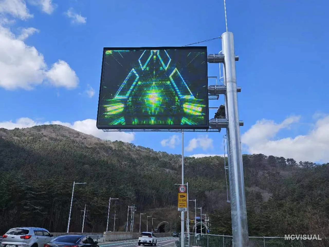 Tunnel approach traffic information display, Busan, South Korea — From the approaching carriageway. A traffic screen is read at speed and at distance, so legibility is set by the approac