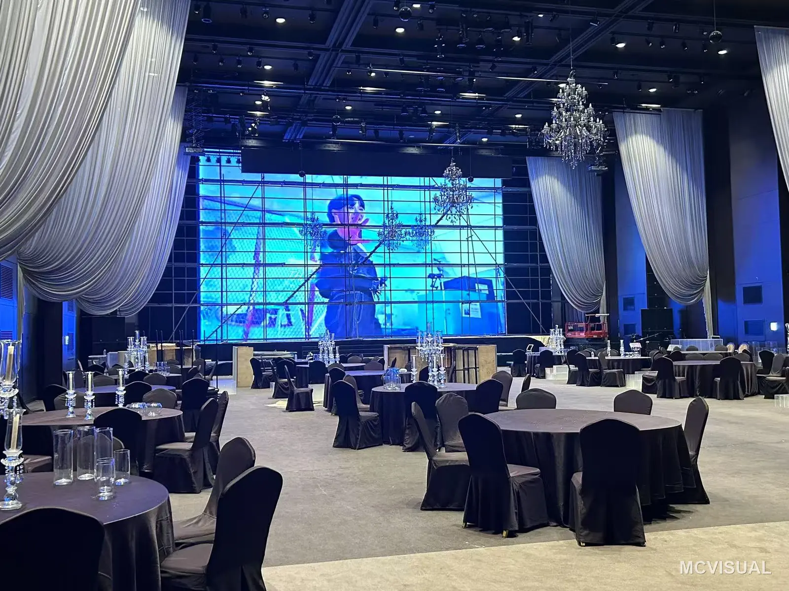 Daejeon banquet and convention hall, Daejeon, South Korea — Handover condition. Drapes back, chandeliers on, screen running the venue's own content — what the client actually