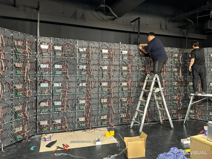 Video production studio, Doksan-dong, Seoul, South Korea — Cabinet backs during the build. Power and data runs are dressed before the modules go on, because on a curve there is no