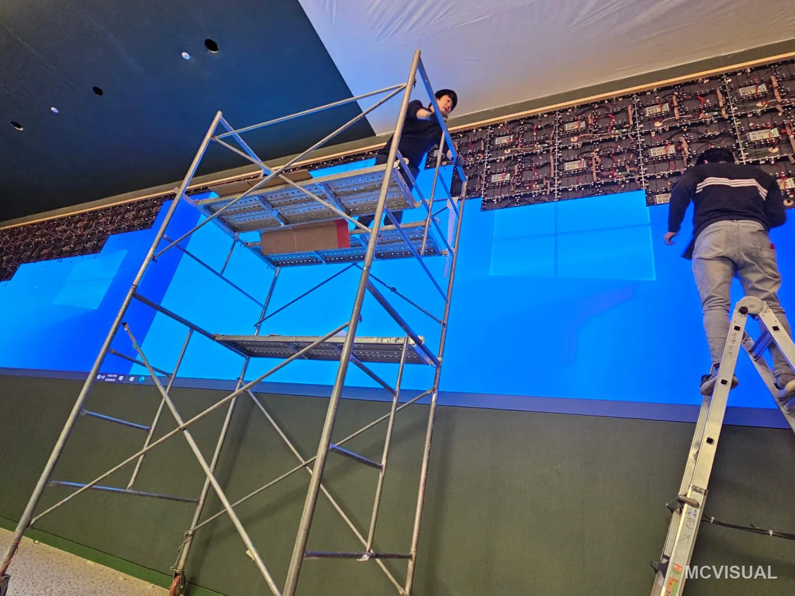 Property sales gallery, South Korea — The 12800 × 2880 mm main wall going up. A sales gallery opens on a fixed date tied to a launch campaign, so the screen p