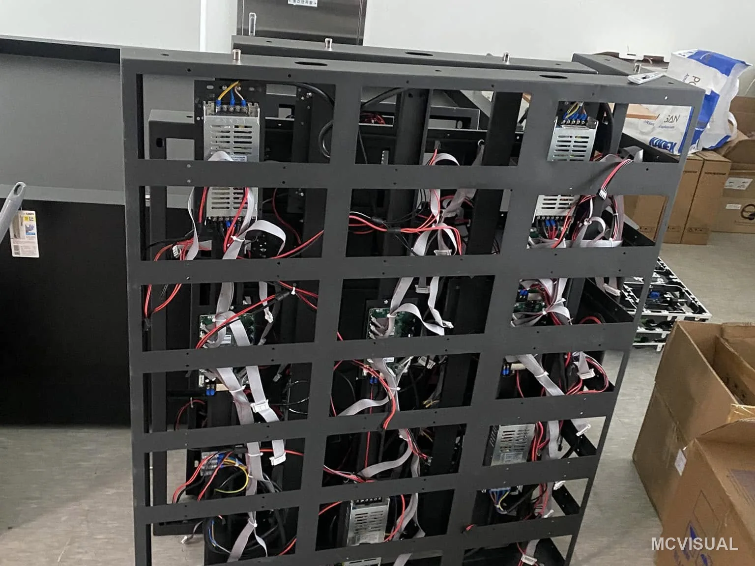 Retail concourse, South Korea — The cabinet back. Lightweight frames are not a spec-sheet detail on a fit-out: every kilogram saved is a lift movement s