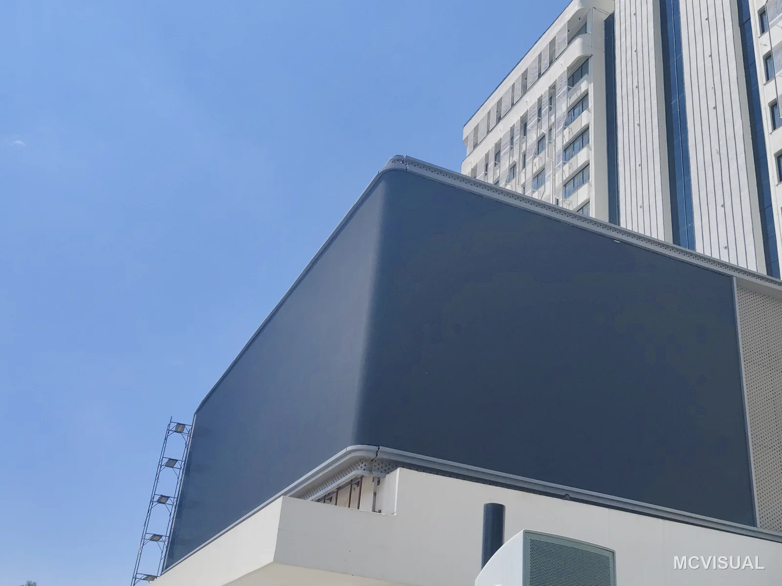 Tower facade advertising screen, South Korea — The screen mounted and blank, before commissioning. The cantilevered steel frame holds it clear of the facade so service
